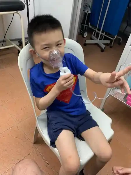 A young boy using a nebulizer mask